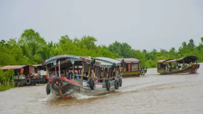 An Binh Islet Tour | A Scenic Mekong River Escape from Can Tho - A traditional boat from the Me Kong Smile tour cruising along a wide river in Vinh Long - 18706