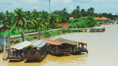 Ben Tre Tour | The Secret of The Coconuts “Capital” - Aerial view of the vast Mekong River on a Ben Tre tour with Mekong Smile, showing lush green coconut groves - 18712