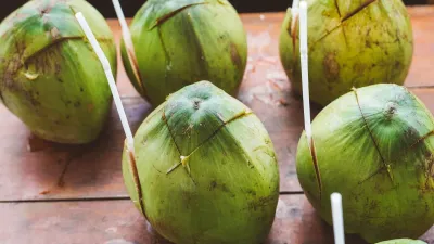 Ben Tre Tour | The Secret of The Coconuts “Capital” - Freshly chopped coconuts with straws, ready for tourists to drink on a Mekong Delta tour - 18715